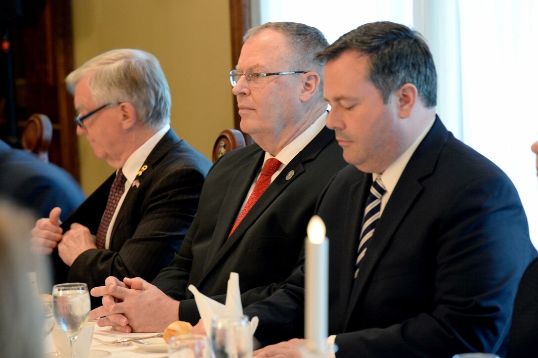 The Honourable Laurie Hawn, left, U.S. Deputy Defense Secretary Bob Work, center, and Minister of Defense Jason Kenney, right, sit at the 234th Permanent Joint Board on Defense dinner at the Army Officer's Mess in Ottawa, Canada, June 15, 2015. 