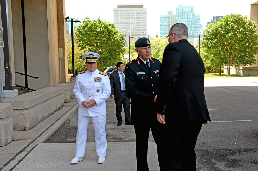 U.S. Deputy Defense Secretary Bob Work, right,  is greeted by Lt. Gen. Guy Thibault, Vice Chief of the Defense Staff at the National Defense Headquarters in Ottawa, Canada, June 15, 2015. 