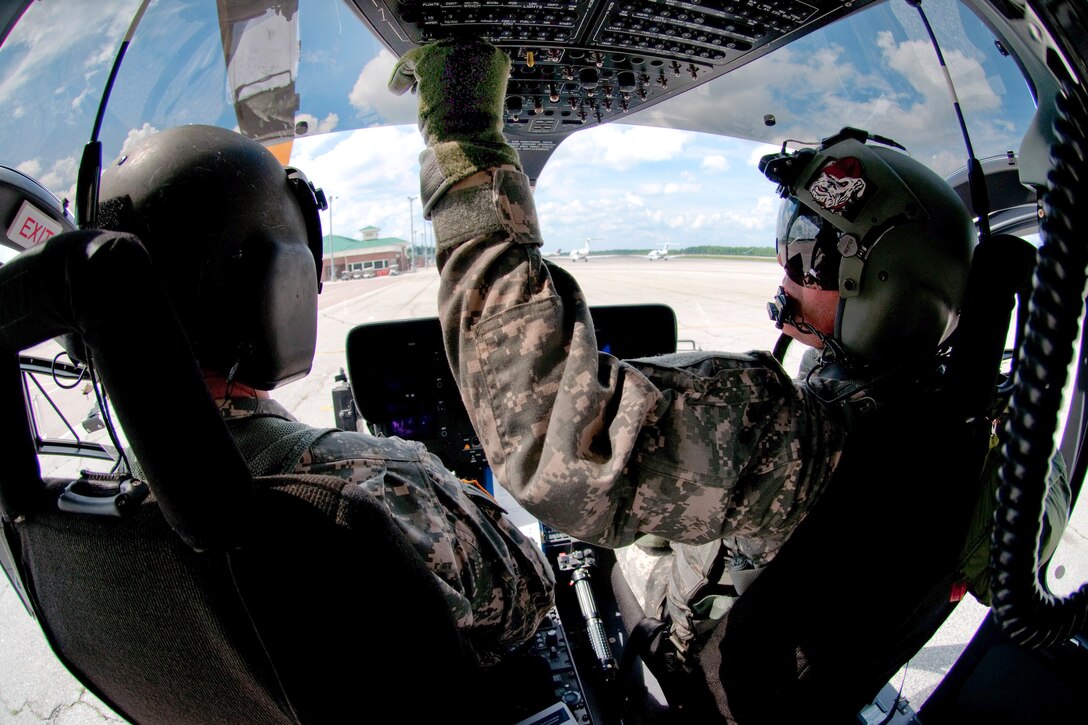 Army Maj. Brian Vorse, left, and Army Cpt. Chris Jones prepare their UH-72A Lakota helicopter for takeoff in Greenville, S.C., June 10, 2015. Vorse and Jones are pilots assigned to the South Carolina National Guard's Company A, 2nd Battalion, 151st Security and Support Aviation Battalion.