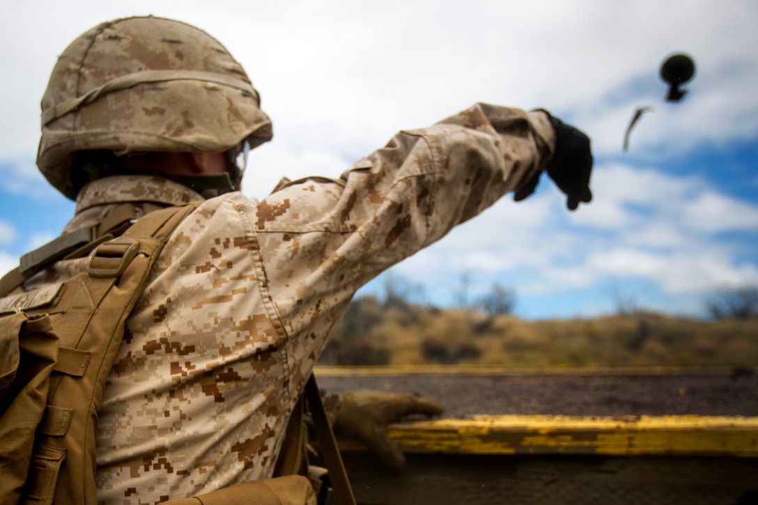 A Marine throws an M67 Grenade into a trench during Operation Lava Viper, a company assault exercise at Pohakuloa Training Area, Hawaii, June 9, 2015.