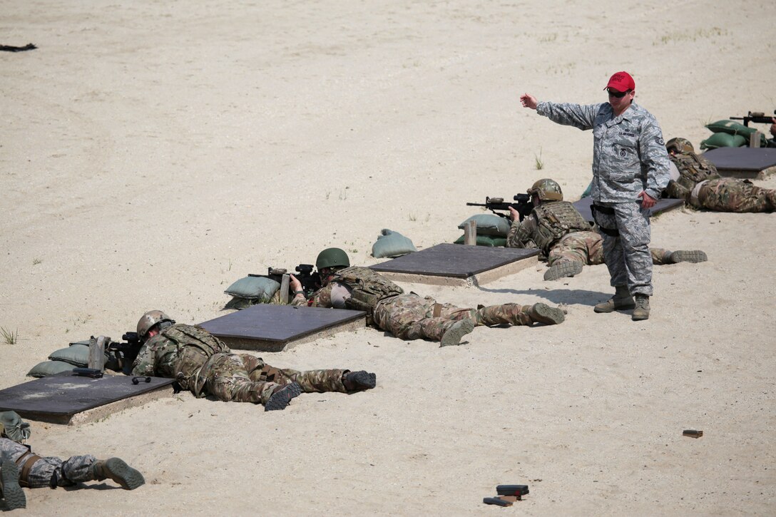 An Air Force range safety officer directs airmen to fire M4 carbines during qualification on Joint Base McGuire-Dix-Lakehurst, N.J., June 10, 2015. 