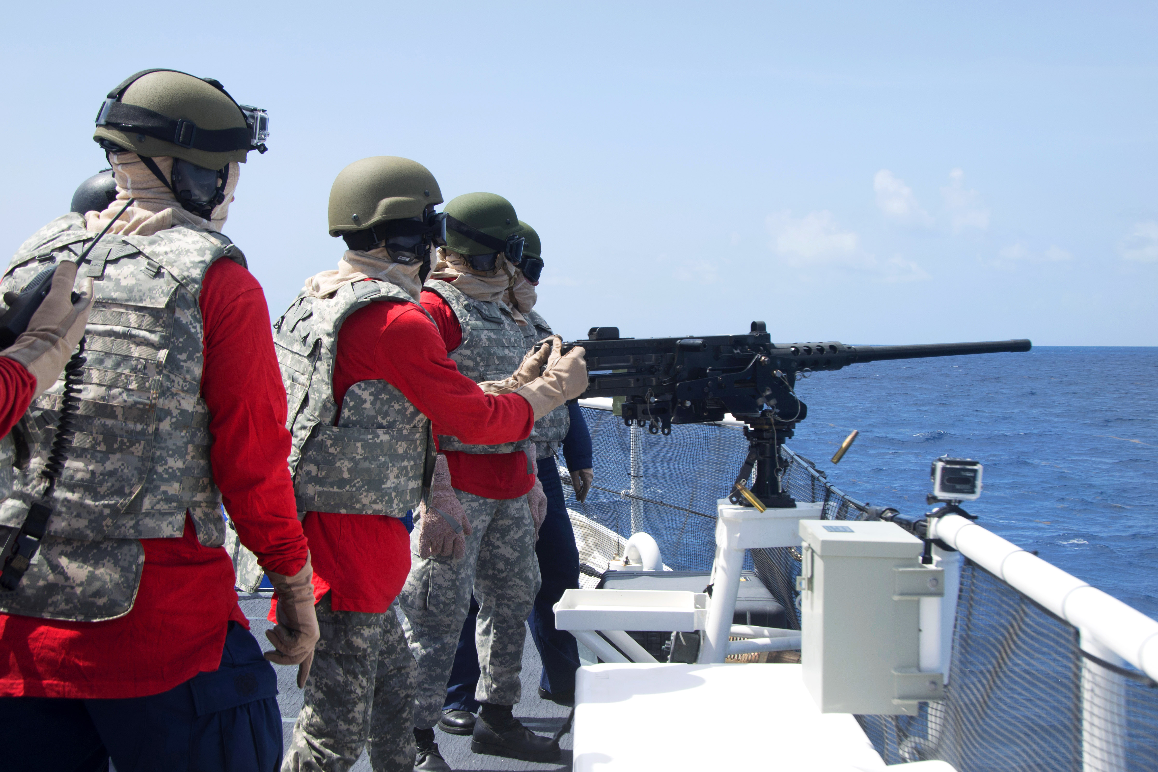 A Dominican sailor fires a .50caliber machine gun aboard the U.S