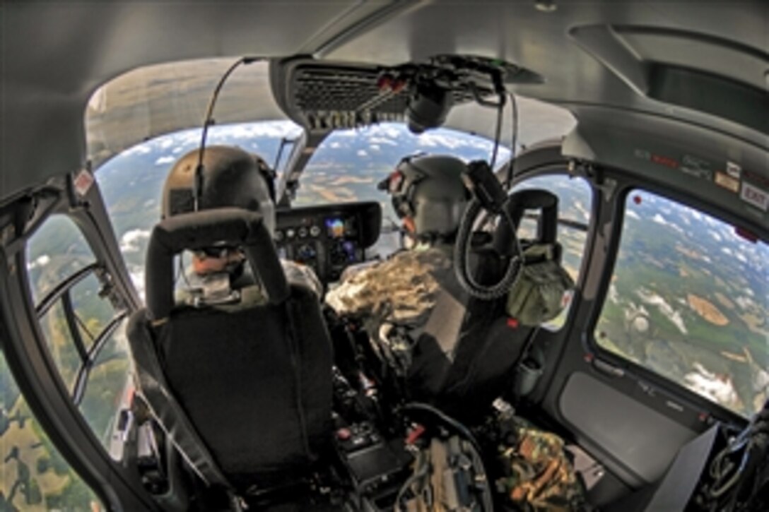 Army Maj. Brian Vorse, left, and Army Cpt. Chris Jones fly a UH-72A Lakota helicopter over South Carolina’s major hurricane escape routes, June 10, 2015. 