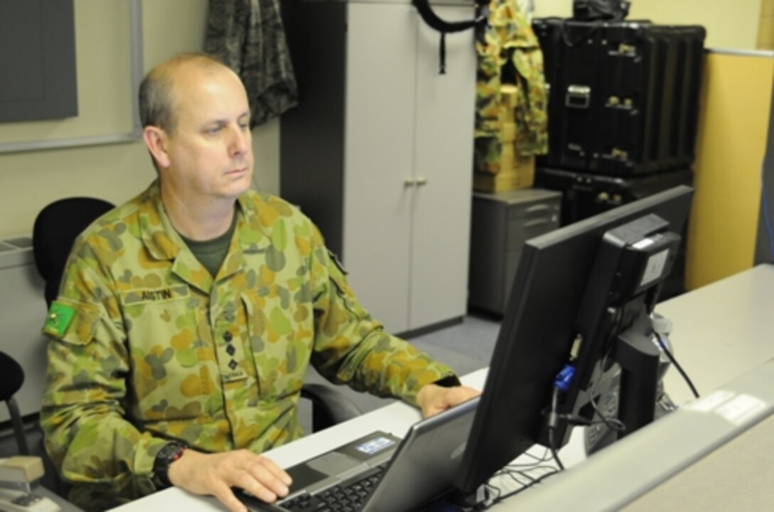 DAEGU, South Korea - The Multi-National Coordination Center Deputy Director, Col. Chris Austin, Australian Defense Force, works at his computer station during the annual combined-joint command post exercise, Ulchi Freedom Guardian 14. The mission of the MNCC is to coordinate force reception, staging and onwards movement of United Nation Command Sending State contributions to support the UNC mission and ROK - led defense on the Korean Peninsula. (Photo by USFK Public Affairs) 