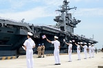 BUSAN, Republic of Korea (Jul. 11, 2014) Republic of Korea sailors wave South Korean and American flags as the aircraft carrier USS George Washington (CVN73) arrives in Busan, Republic of Korea for a scheduled port visit. George Washington is forward deployed to Yokosuka, Japan in the U.S. 7th Fleet area of responsibility supporting regional security and stability in the Indo-Asia Pacific Region. (U.S. Navy photo by Mass Communication Specialist 1st Class Frank L. Andrews/Released) 