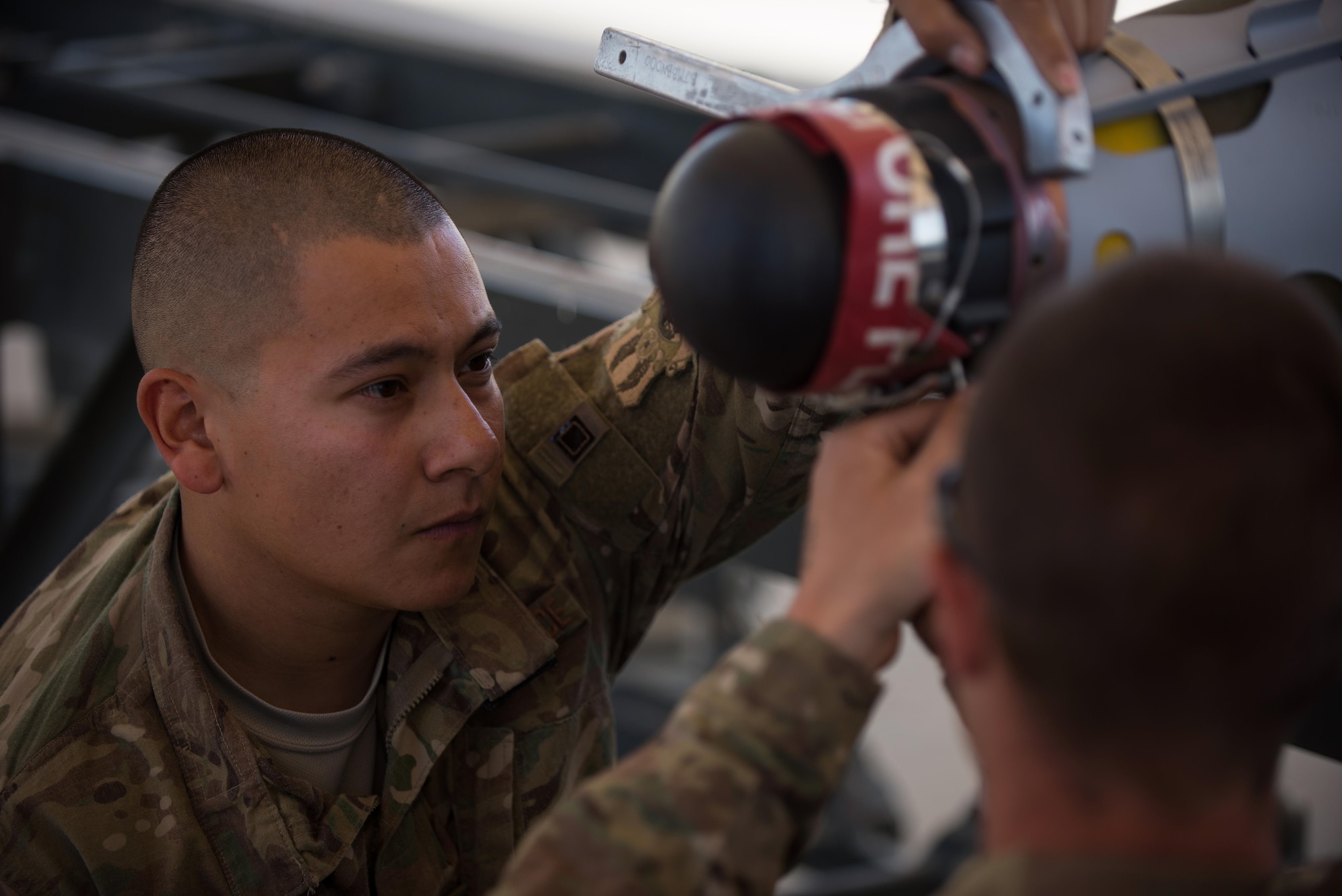 U.S. Air Force Staff Sgt. Luis Soto, 455th Expeditionary Maintenance Squadron Munitions Flight conventional maintenance/precision guided munitions production superintendent, supervises a munitions Airman as he performs a six month inspection on a Guided Bomb Unit-54 (GBU-54) munition at Bagram Airfield, Afghanistan, June 15, 2015. The 455th EMXS Munitions Flight ensures that every munition loaded onto an F-16 Fighting Falcon will perform as expected when used. (U.S. Air Force photo by Tech. Sgt. Joseph Swafford/Released)