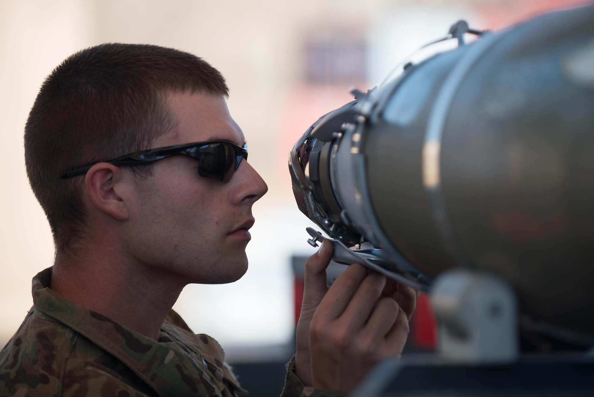 U.S. Air Force Airmen 1st Class Aaron Funck, 455th Expeditionary Maintenance Squadron Munitions Flight munitions technician, completes a six month inspection on a Guided Bomb Unit-54 (GBU-54) munition at Bagram Airfield, Afghanistan, June 15, 2015. The 455th EMXS Munitions Flight ensures that every munition loaded onto an F-16 Fighting Falcon will perform as expected when used. (U.S. Air Force photo by Tech. Sgt. Joseph Swafford/Released)