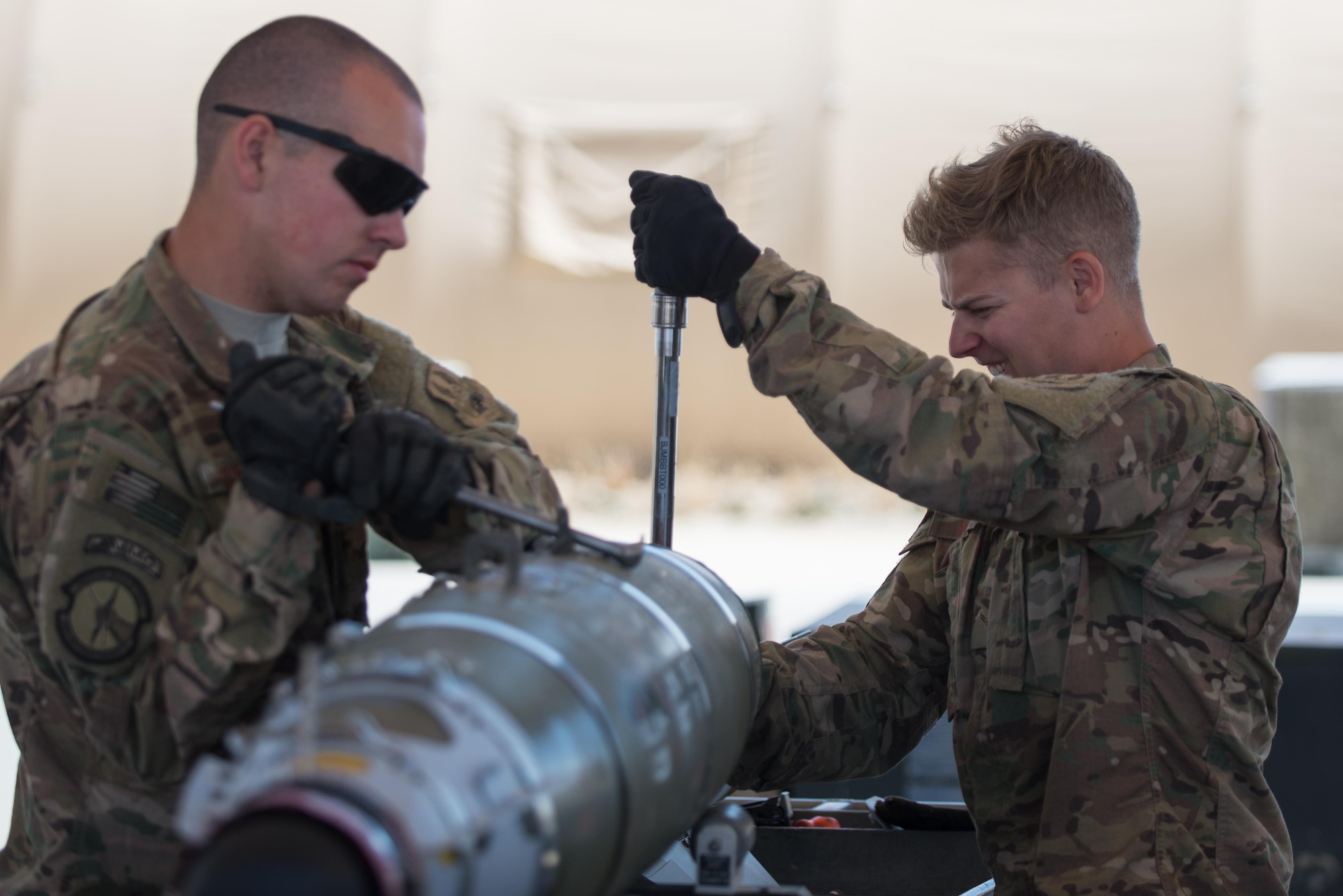 U.S. Air Force Airman 1st Class Matthew Mardis, right, and Airman 1st Class James Griffin, both assigned to the 455th Expeditionary Maintenance Squadron Munitions Flight, complete a six month inspection on a Guided Bomb Unit-54 (GBU-54) munition at Bagram Airfield, Afghanistan, June 15, 2015. The 455th EMXS Munitions Flight ensures that every munition loaded onto an F-16 Fighting Falcon will perform as expected when used. (U.S. Air Force photo by Tech. Sgt. Joseph Swafford/Released)