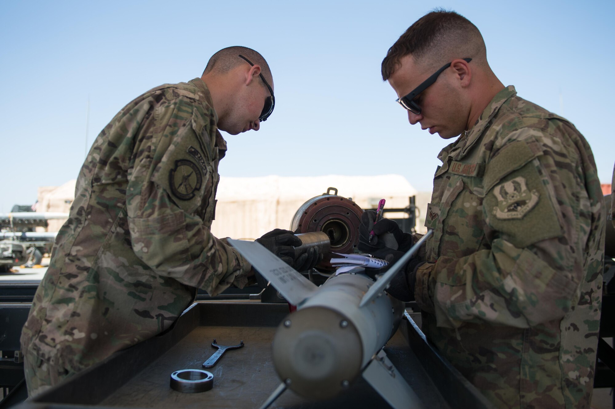 U.S. Air Force Senior Airman Michael Rose, right, and Airman 1st Class James Griffin, both assigned to the 455th Expeditionary Maintenance Squadron Munitions Flight, complete a six month inspection on a Guided Bomb Unit-54 (GBU-54) munition at Bagram Airfield, Afghanistan, June 15, 2015. The 455th EMXS Munitions Flight ensures that every munition loaded onto an F-16 Fighting Falcon will perform as expected when used. (U.S. Air Force photo by Tech. Sgt. Joseph Swafford/Released)
