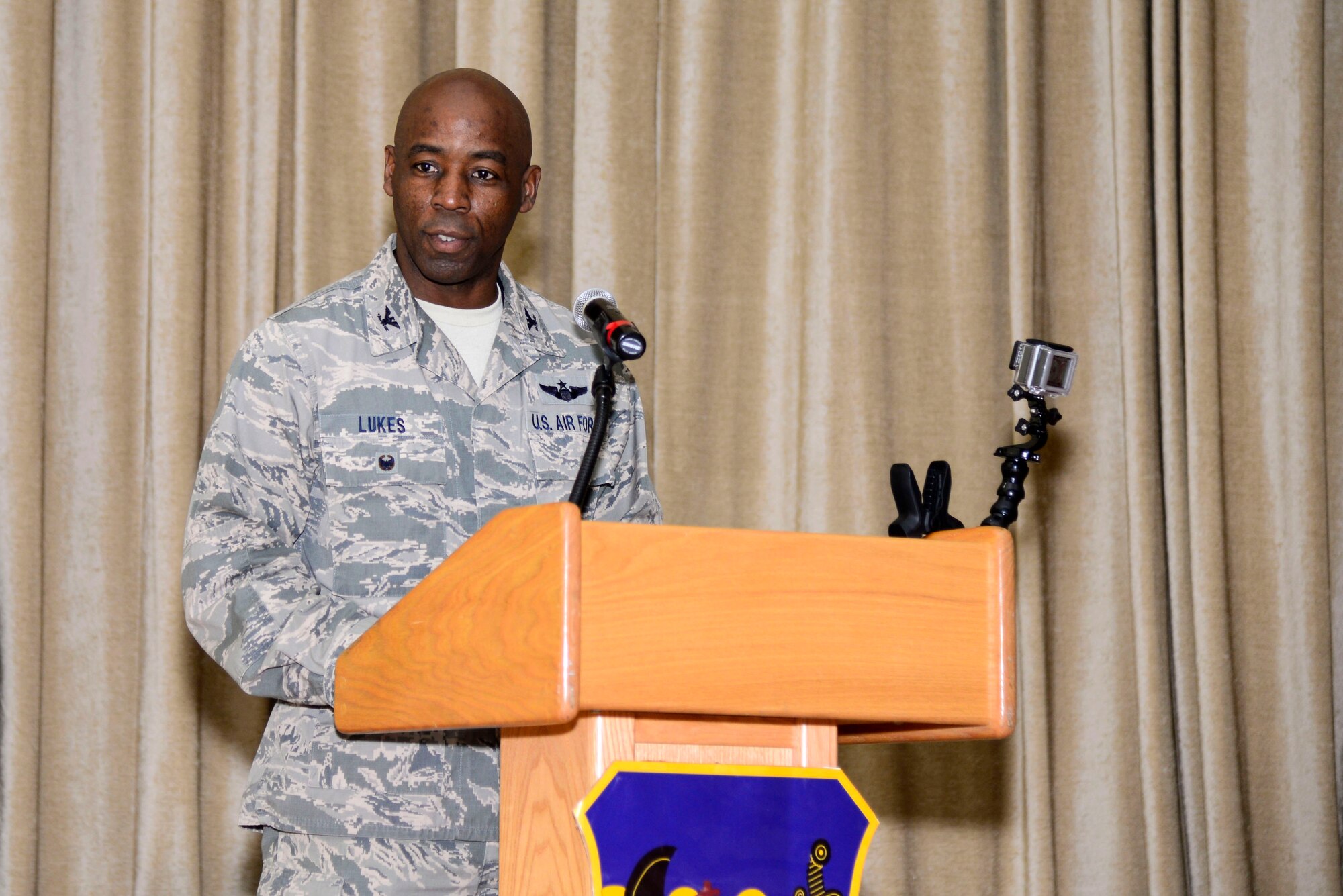 U.S. Air Force Col. Clarence Lukes Jr., 386th Air Expeditionary Wing commander, gives final remarks during a change of command ceremony at an undisclosed location in Southwest Asia, June 15, 2015. Lukes shared his command vision for moving forward by focusing on the road ahead. (U.S. Air Force photo by Senior Airman Racheal E. Watson)