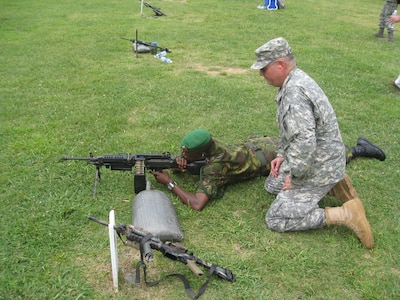 Botswana Defence Force Brig. Gen. George Tlhalerwa fires a squad automatic
weapon as Army Col. Jeffery Brotherton, North Carolina National Guard,
observes, Aug. 17, 2009, at the Camp Butner National Guard Training Center
in North Carolina. The event, a State Partnership Program initiative, gave a
delegation of officers and civilians from Botswana an opportunity to see
U.S. training facilities and weapons ranges.