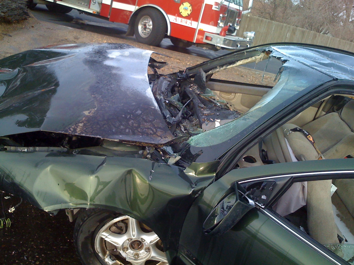 Remains of a green sedan following a fiery, one-car crash on Airport Road in Aurora, Colo., March 6, 2011. Seven Soldiers and Airmen rescued two victims from the burning car. The group was composed of Colorado National Guardmembers and Army Reservists who were on their way to drill that morning.