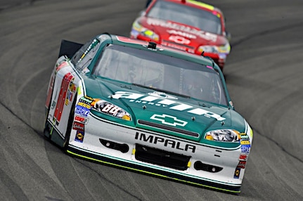 Dale Earnhardt Jr., driver of the No. 88 National Guard NASCAR racecar, races around the track at Auto Club Speedway in Fontana, Calif., March 27, 2011. Dale Jr. finished the day with a 12th place finish, moving him down into 12th place in the points race.