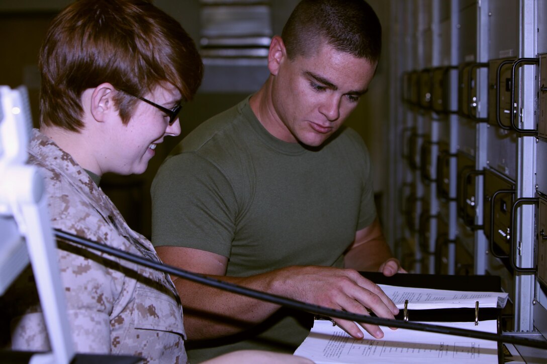 Cpl. Kristen Hirst, left, runs a communication test on a communications service monitor with the assistance of Cpl. Brian Jordan at Marine Corps Air Station Cherry Point, N.C., June 16, 2015. Air traffic control Marines receive additional training once they arrive on the air station to familiarize themselves with equipment specific to the site. Hirst is an air traffic control communications technician trainee and Jordan is an air traffic control communications technician, both with Head quarters and Headquarters Squadron.