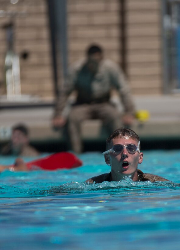 Lance Cpl. Alex S. Carroll, machine gunner with Bravo Company, 4th Reconnaissance Battalion, 4th Marine Division, Marine Forces Reserve, performs a 500-meter swim as part of the reconnaissance assessment at the Combat Center Training Tank at Marine Corps Air Ground Combat Center Twentynine Palms, Calif., June 16, 2015. In order to pass the assessment, a Marine must be able to complete the 500-meter swim in a predetermined amount of time. (U.S. Marine Corps photo by Cpl. Ian Leones/Released)