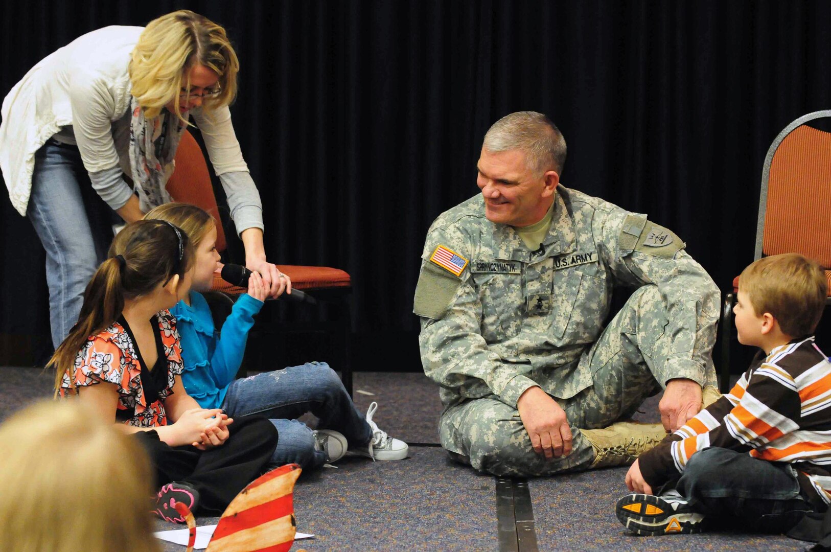 Army Maj. Gen. David Sprynczynatyk, the North Dakota adjutant general, answers impromptu questions from children of North Dakota National Guard members during the 2011 professional development workshop Mar. 5,2011.