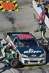 The pit crew of Dale Earnhardt Jr.,driver of the No. 88 National Guard NASCAR racecar, works quickly to change the two right-side tires, at the Martinsville Speedway in Martinsville, Va., April 3, 2011. The pit stop was a strategic move by crew chief Steve Letarte that put the No. 88 team in second place coming out of the pits on lap 210.