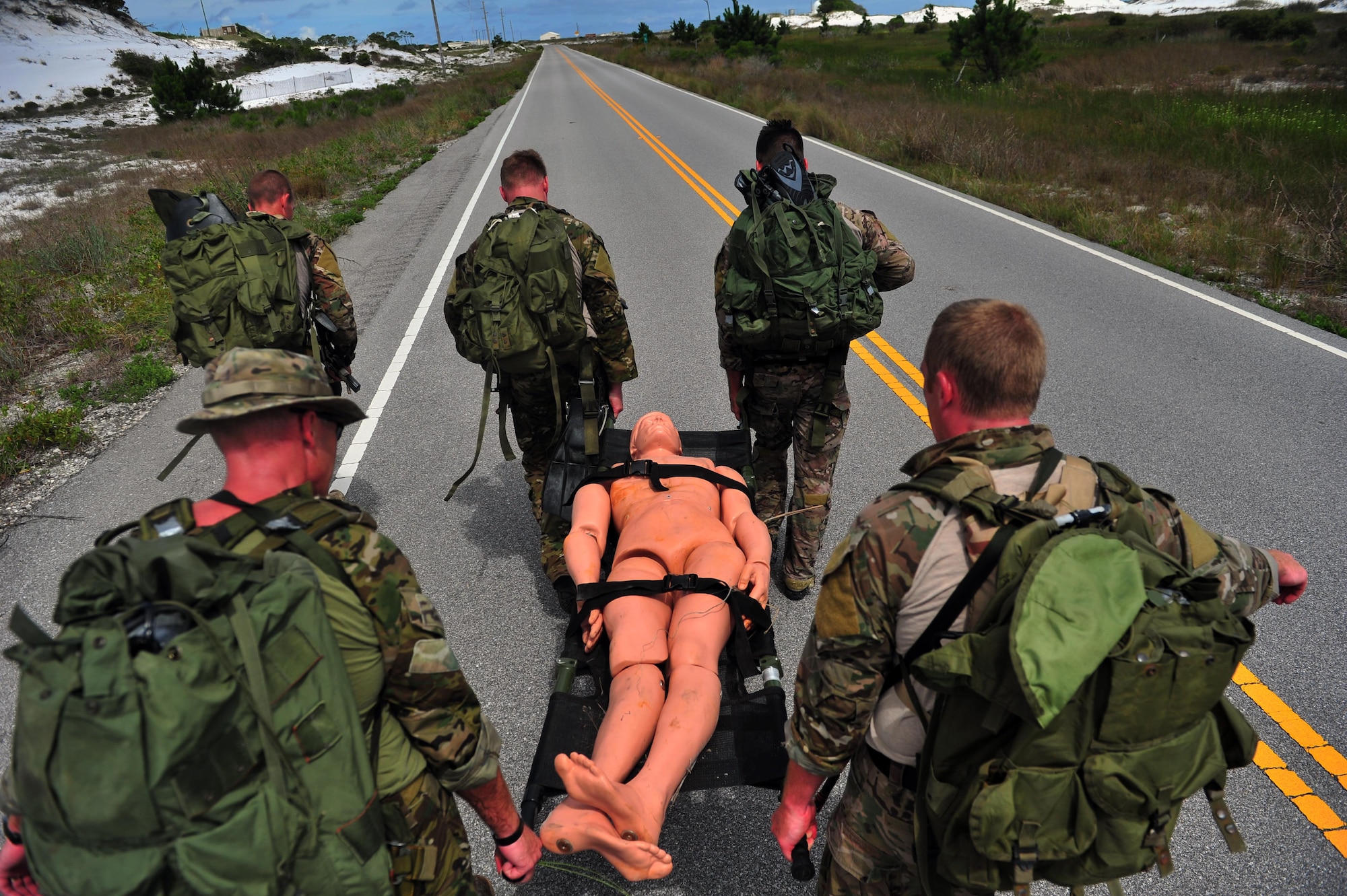Special Tactics Airmen find and extract a simulated casualty using a kit carry during a Monster Mash training event, June 11, 2015, at Spectre Island on Eglin Range, Fla. Monster Mash is a long-standing special tactics training tradition, consisting of an obstacle course where special operators complete timed scenarios at different stations of core mission training. (U.S. Air Force photo by Airman 1st Class Ryan Conroy/Released) 