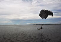 A Special Tactics Airman parachutes into the water during a Monster Mash training event, June 11, 2015, at Spectre Island on Eglin Range, Fla. Monster Mash is a long-standing special tactics training tradition, consisting of an obstacle course where special operators complete timed scenarios at different stations of core mission training. The scenario called for Airmen to infiltrate a simulated hostile territory to conduct a combat search and rescue on downed personnel. (U.S. Air Force photo by Airman 1st Class Ryan Conroy/Released)