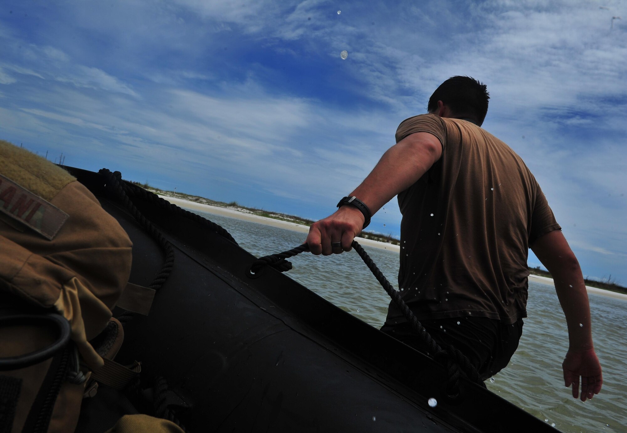 A Special Tactics Airman pulls a zodiac boat to shore during a Monster Mash training event, June 11, 2015, at Spectre Island on Eglin Range, Fla. Monster Mash is a long-standing special tactics training tradition, consisting of an obstacle course where special operators complete timed scenarios at different stations of core mission training.(U.S. Air Force photo by Airman 1st Class Ryan Conroy/Released) 