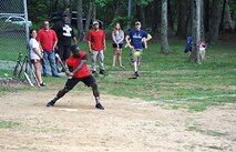 Family member Derek Lazarus keeps his eye on the ball during a softball game June 5 as part of the U.S. Army Engineering and Support Center, Huntsville's organization day picnic.