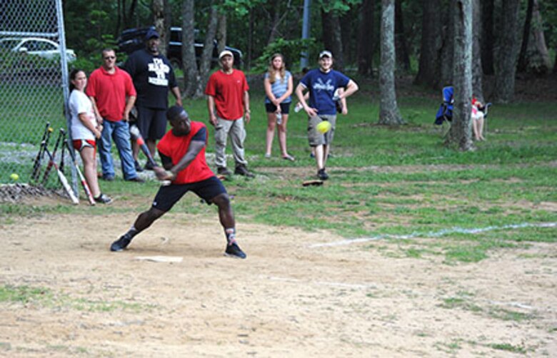 Family member Derek Lazarus keeps his eye on the ball during a softball game June 5 as part of the U.S. Army Engineering and Support Center, Huntsville's organization day picnic.