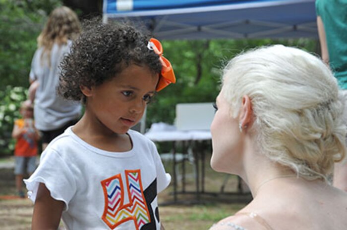 Mary Vaughn, daughter of assistant attorney Nancy Vaughn, speaks with "Elsa" at the U.S. Army Engineering and Support Center, Huntsville, organization day picnic June 5 at Monte Sano State Park in Huntsville.  