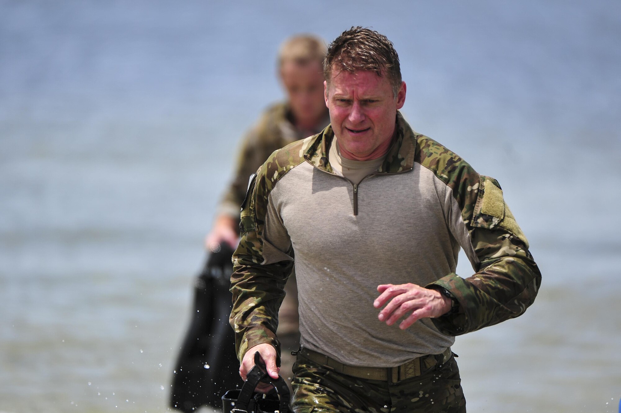 Col. Eric Ray, 24th Special Operation Wing vice commander, emerges from the Santa Rosa Sound during a Monster Mash training event on Eglin Range, Fla., June 11, 2015. Monster Mash is a long-standing special tactics training tradition, consisting of an obstacle course where special operators complete timed scenarios at different stations of special tactics core mission training. (U.S. Air Force photo/Senior Airman Jeff Parkinson)
