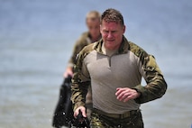 Col. Eric Ray, 24th Special Operation Wing vice commander, emerges from the Santa Rosa Sound during a Monster Mash training event on Eglin Range, Fla., June 11, 2015. Monster Mash is a long-standing special tactics training tradition, consisting of an obstacle course where special operators complete timed scenarios at different stations of special tactics core mission training. (U.S. Air Force photo/Senior Airman Jeff Parkinson)
