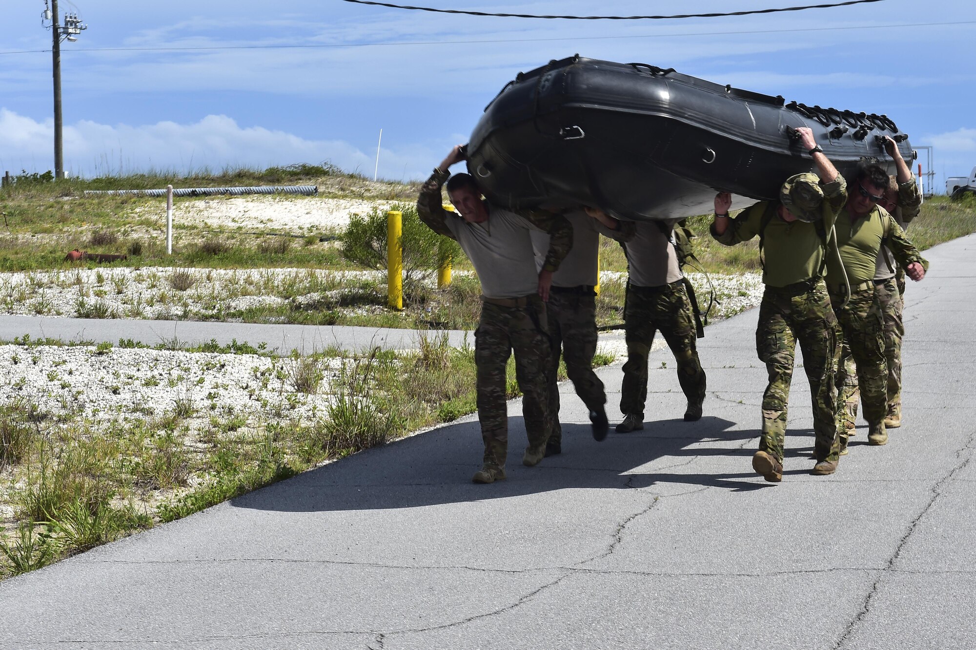 Special Tactics Airmen from the 24th Special Operations Wing carry a zodiac boat into the Santa Rosa Sound during a Monster Mash training event on Eglin Range, Fla., June 11, 2015. Monster Mash is a long-standing special tactics training tradition, consisting of an obstacle course where special operators complete timed scenarios at different stations of special tactics core mission training. (U.S. Air Force photo/Senior Airman Jeff Parkinson)
