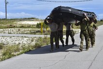 Special Tactics Airmen from the 24th Special Operations Wing carry a zodiac boat into the Santa Rosa Sound during a Monster Mash training event on Eglin Range, Fla., June 11, 2015. Monster Mash is a long-standing special tactics training tradition, consisting of an obstacle course where special operators complete timed scenarios at different stations of special tactics core mission training. (U.S. Air Force photo/Senior Airman Jeff Parkinson)
