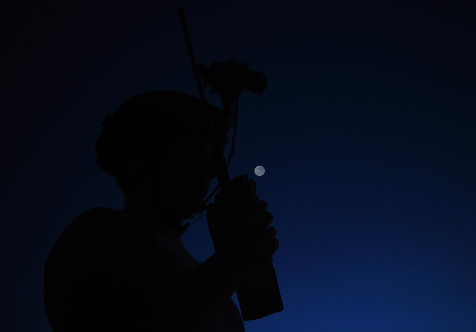 Senior Airman Caleb Brooks, 1st Special Operations Security Forces Squadron deployed aircraft ground response element, communicates target coordinates to a AC-130 “Spooky” gunship during a call for fire exercise, June 16, 2015, at Eglin Range, Fla. Aircrew members communicated closely with ground-range operators to ensure the gunship's rounds hit simulated enemy targets. (U.S. Air Force photo by Airman 1st Class Ryan Conroy/Released)