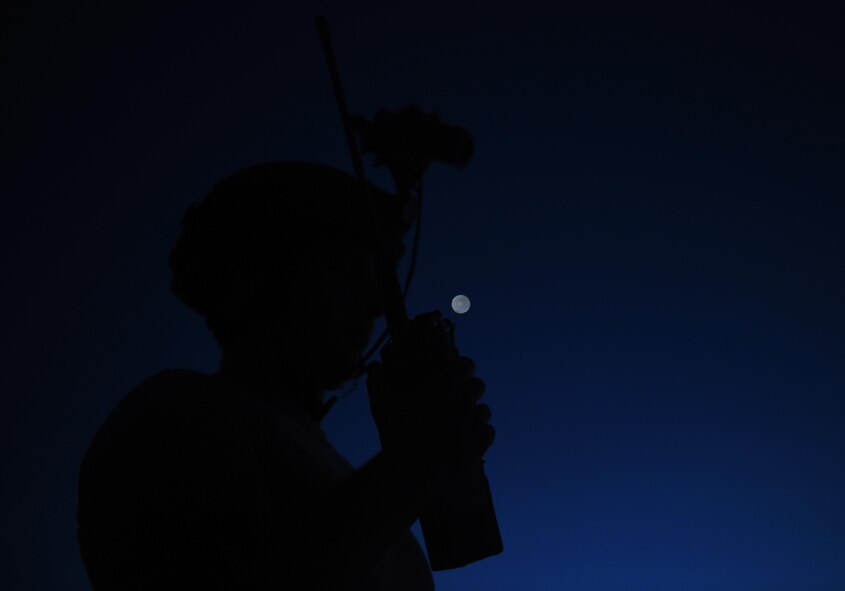 Senior Airman Caleb Brooks, 1st Special Operations Security Forces Squadron deployed aircraft ground response element, communicates target coordinates to a AC-130 “Spooky” gunship during a call for fire exercise, June 16, 2015, at Eglin Range, Fla. Aircrew members communicated closely with ground-range operators to ensure the gunship's rounds hit simulated enemy targets. (U.S. Air Force photo by Airman 1st Class Ryan Conroy/Released)