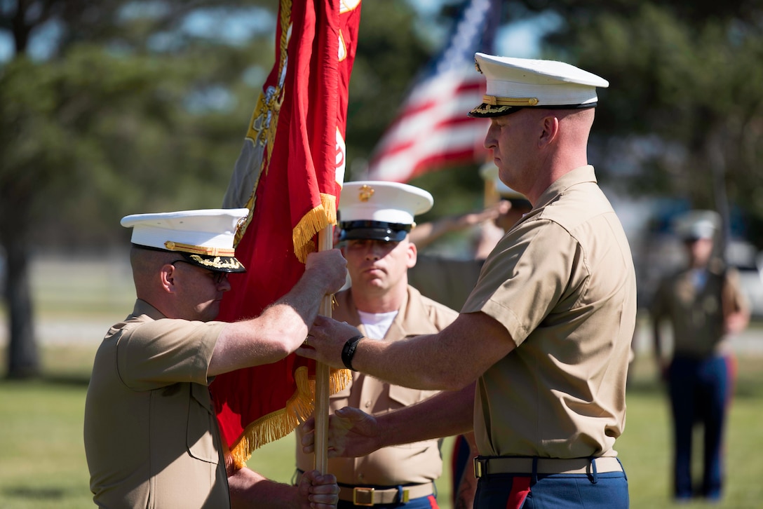 U.S. Marine Corps Maj. Lance Day, off going commanding officer, Recruiting Station Salt Lake City (RS SLC), passes the Marine Corps Colors to Maj. Peter Ankney, oncoming commanding officer, RS SLC, to signify the change of command for RS SLC at Hill Air Force Base, Utah, June 12. (U.S. Marine Corps photo by Sgt. Daniel Wetzel)