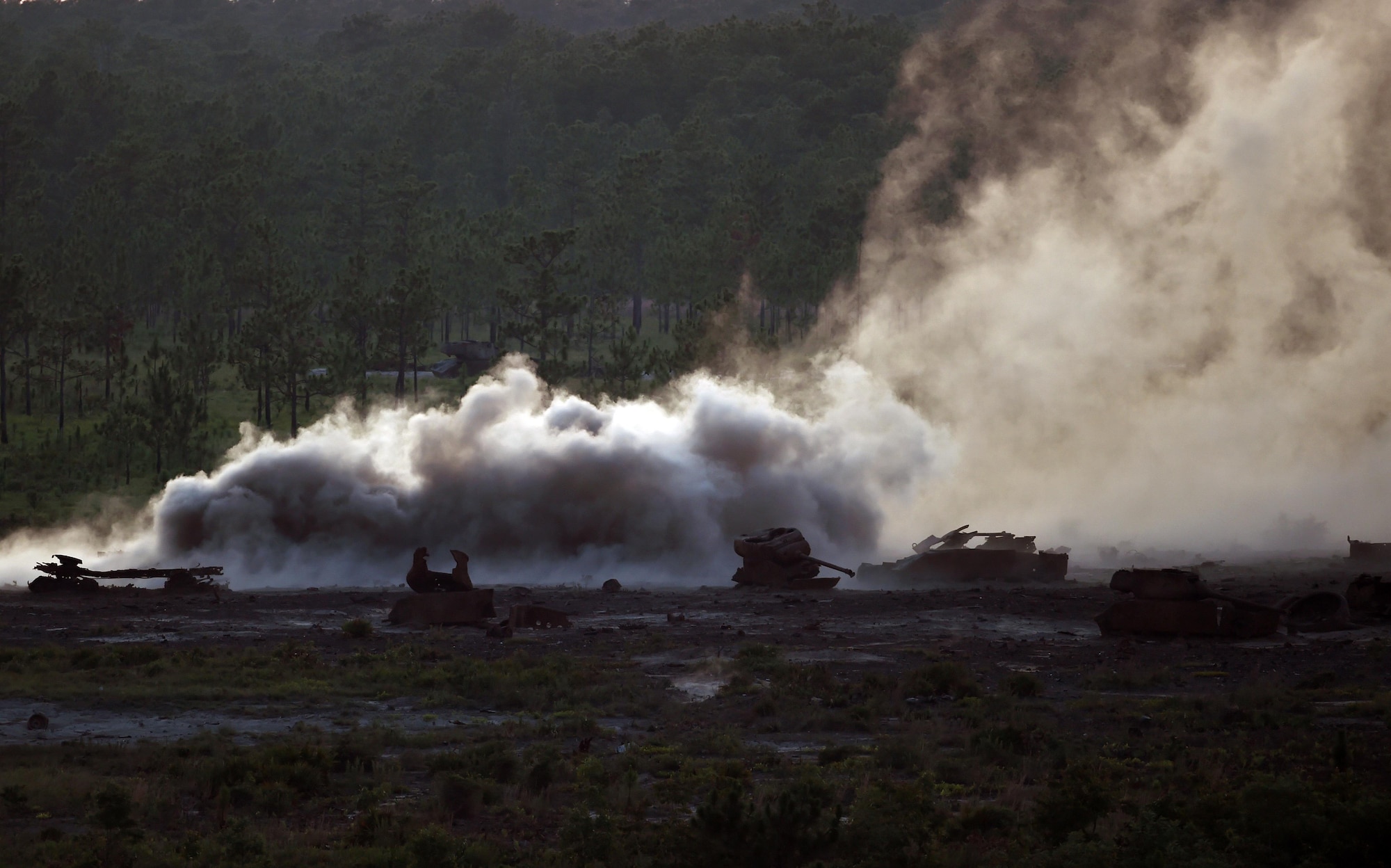 Smoke rises from the aftermath of a 105mm howitzer round hitting a target during live-fire training, June 16, 2015, at Eglin Range, Fla. Aircrew members communicated closely with ground-range operators to ensure the gunship's rounds hit simulated enemy targets. (U.S. Air Force photo by Airman 1st Class Ryan Conroy/Released)
