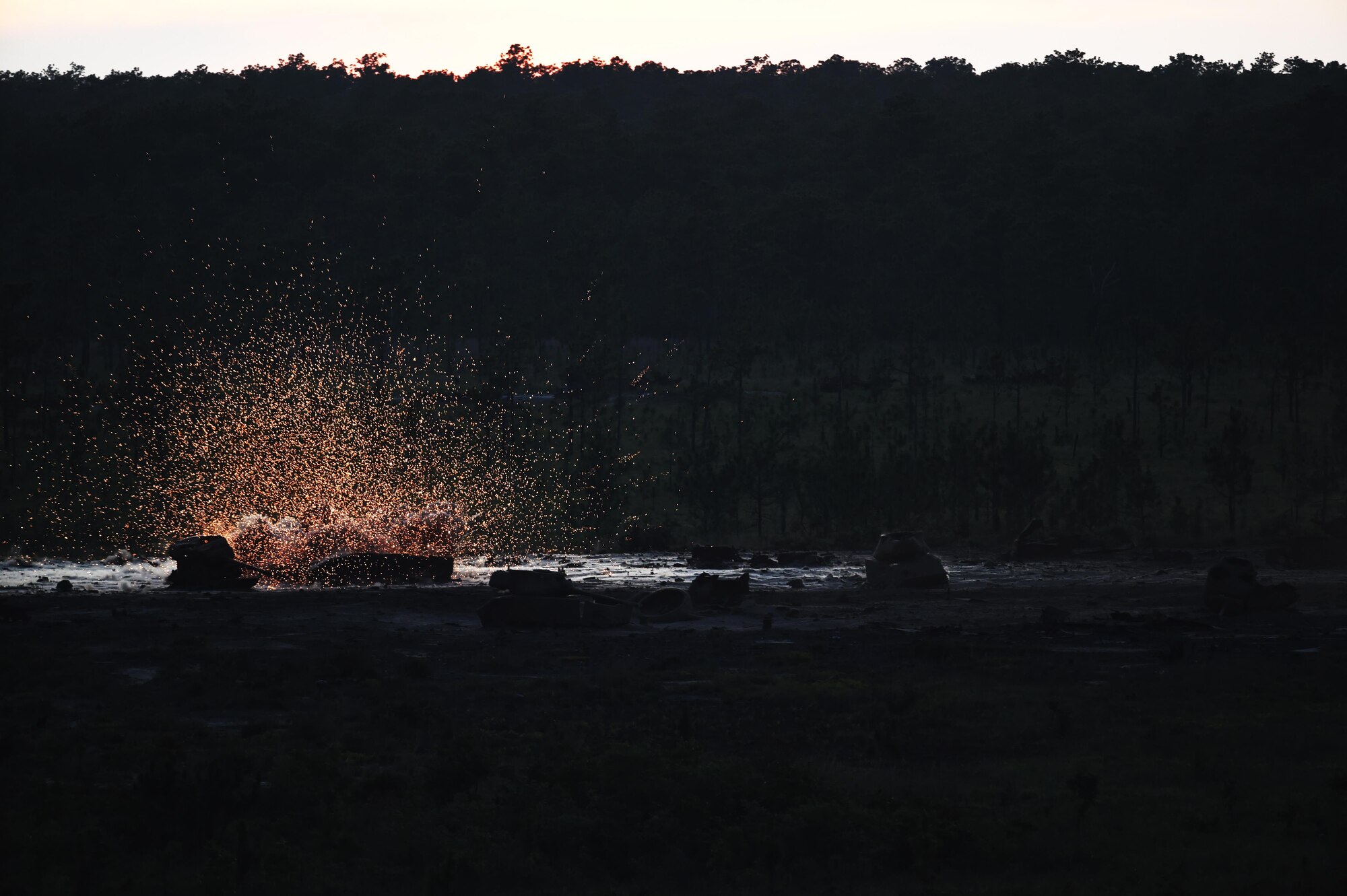 A 105mm howitzer round fired from an AC-130U “Spooky” gunship hits a target during live-fire training, June 16, 2015, at Eglin Range, Fla. Aircrew members communicated closely with ground-range operators to ensure the gunship's rounds hit simulated enemy targets. (U.S. Air Force photo by Airman 1st Class Ryan Conroy/Released)