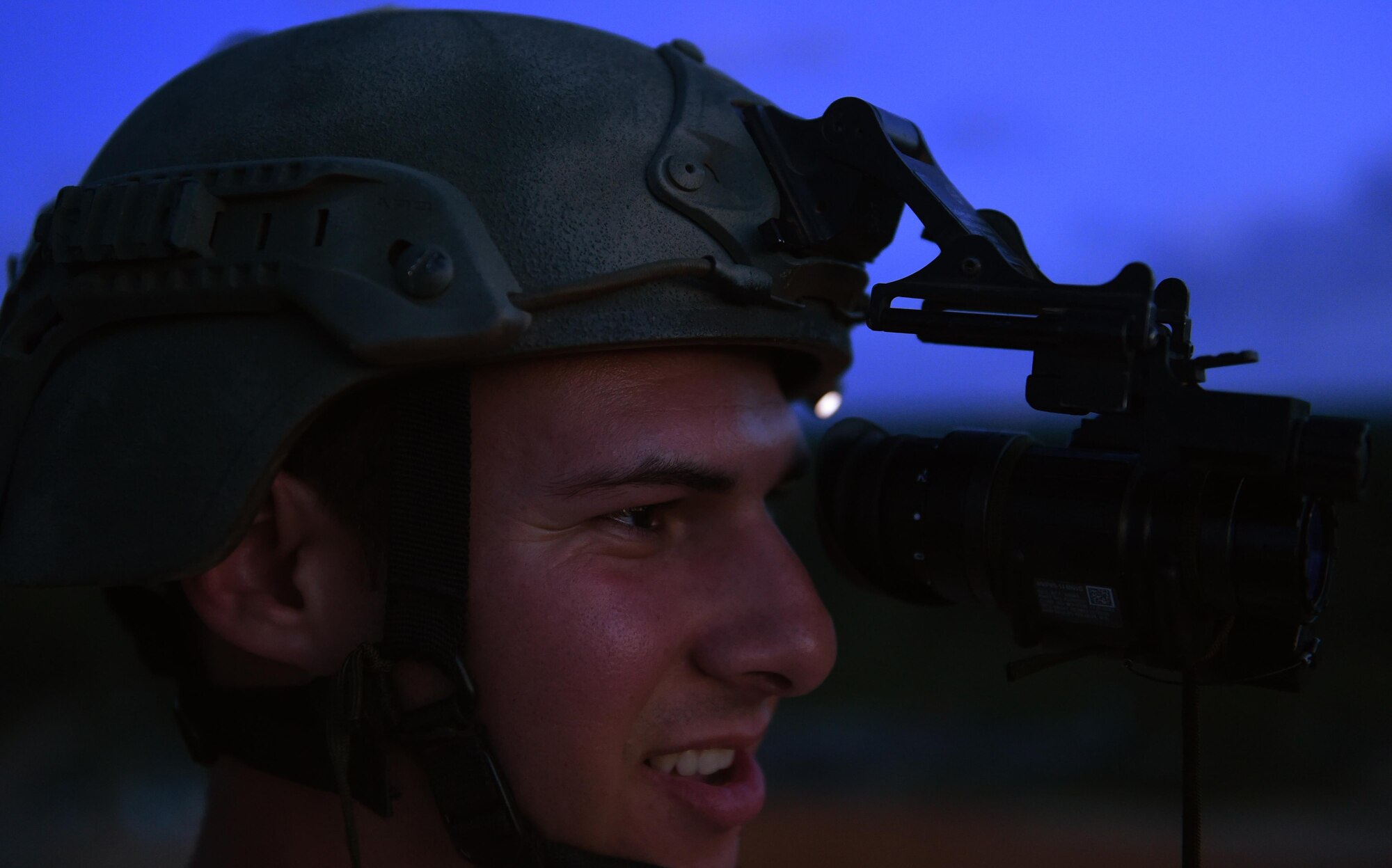Senior Airman Caleb Brooks, 1st Special Operations Security Forces Squadron deployed aircraft ground response element, watches 105mm howitzer rounds hit a target during live-fire training, June 16, 2015, at Eglin Range, Fla. Aircrew members communicated closely with ground-range operators to ensure the gunship's rounds hit simulated enemy targets. (U.S. Air Force photo by Airman 1st Class Ryan Conroy/Released)