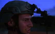 Senior Airman Caleb Brooks, 1st Special Operations Security Forces Squadron deployed aircraft ground response element, watches 105mm howitzer rounds hit a target during live-fire training, June 16, 2015, at Eglin Range, Fla. Aircrew members communicated closely with ground-range operators to ensure the gunship's rounds hit simulated enemy targets. (U.S. Air Force photo by Airman 1st Class Ryan Conroy/Released)