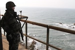BAENGNYEONGDO ISLAND, South Korea – A Republic of Korea Marine scans the horizon from an outpost just 17 km (10.5 miles) from the shores of North Korea, and just 7 km (4.3 miles) from the “Northern Limit Line,” the water boundary of between the two nations. The island, known to Americans as “PY-do,” and to South Koreans as “Baengnyeongdo,” has been a flashpoint in relations between North and South Korea. North Korea sunk the South Korean naval vessel Cheonan near the island March 26, 2010, killing 46 sailors, and fired artillery shells at the nearby Yeonpyeong Island Nov. 23, 2010, killing two South Korean Marines and two civilians.(U.S. Army photo by Staff Sgt. Keith Anderson, U.S. Forces Korea PAO) 