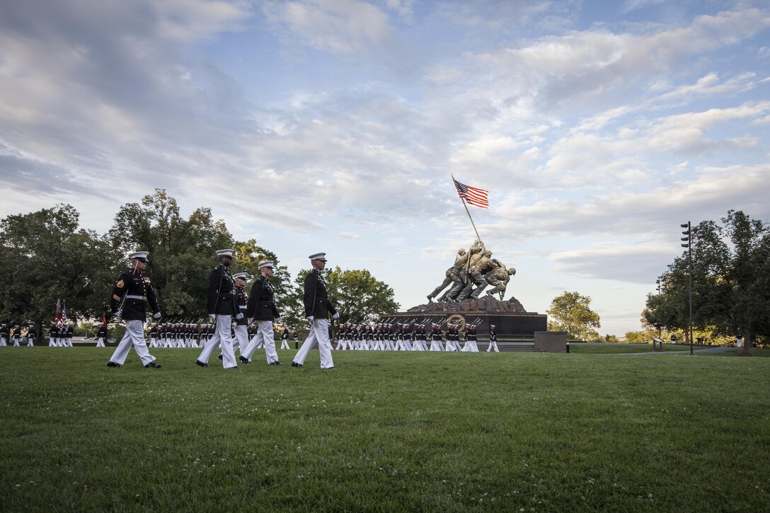 U.S. Marines with Marine Barracks Washington perform during a sunset parade at the Marine Corps War Memorial, Arlington, Va., June 16, 2015. The Honorable Stephen A. Womack, congressman, R-Ark., was the guest of honor for the parade and Lt. Gen. William M. Faulkner, deputy commandant, Installations and Logistics Command, was the hosting official for that same parade. Since September 1956, marching and musical units from Marine Barracks Washington, D.C., have been paying tribute to those who’s “Uncommon valor was a common virtue” by presenting sunset parades in the shadow of the 32-foot high figures of the United States Marine Corps War Memorial. (U.S. Marine Corps photo by Sgt. Melissa Marnell/Released)

