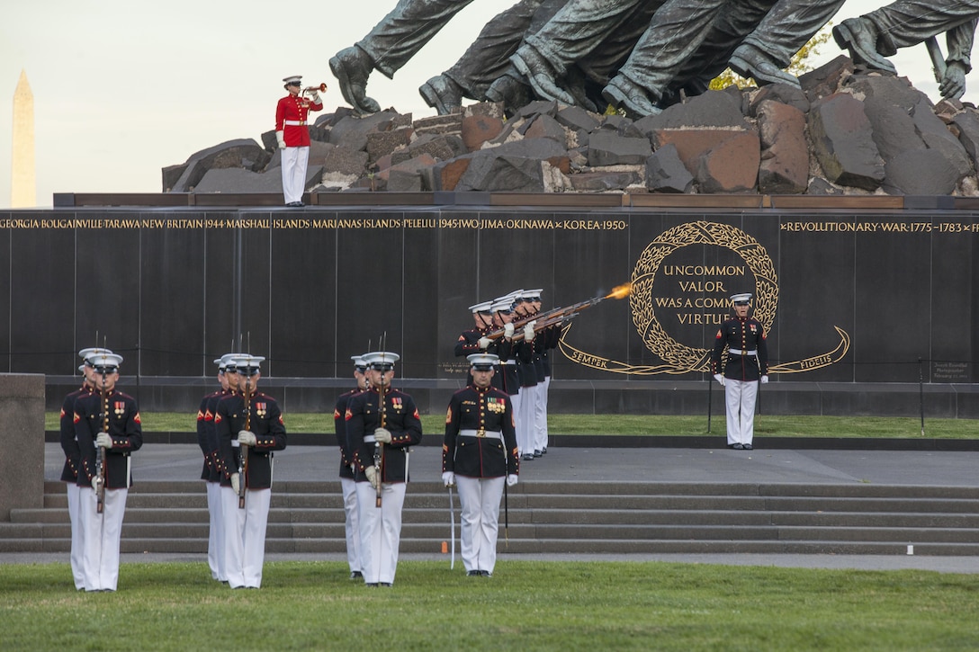 U.S. Marines Marine Barracks Washington perform during the sunset parade at the Marine Corps War Memorial, Arlington, Va., June 16, 2015. The Honorable Stephen A. Womack, congressman, R-Ark., was the guest of honor for the parade, and U.S. Marine Corps Lt. Gen. William M. Faulkner, deputy commandant, Installations and Logistics command, was the hosting official. Since September 1956, marching and musical units from Marine Barracks Washington, D.C., have been paying tribute to those who’s “Uncommon valor was a common virtue” by presenting sunset parades in the shadow of the 32-foot high figures of the United States Marine Corps War Memorial. (U.S. Marine Corps photo by Lance Cpl. Alejandro Sierras/ Released)

