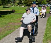 Col. Brian McDaniel, 92nd Air Refueling Wing commander, pushes Gent Powell, a Marine veteran, in a wheelchair to the Rotary Club of Spokane’s veterans’ picnic June 16, 2015, at Manito Park in Spokane, Wash. Roughly 25 veterans from the Spokane Veterans Home were in attendance to eat, listen to music and visit with local service members from Fairchild Air Force Base. (U.S. Air Force photo/Staff Sgt. Veronica Montes)