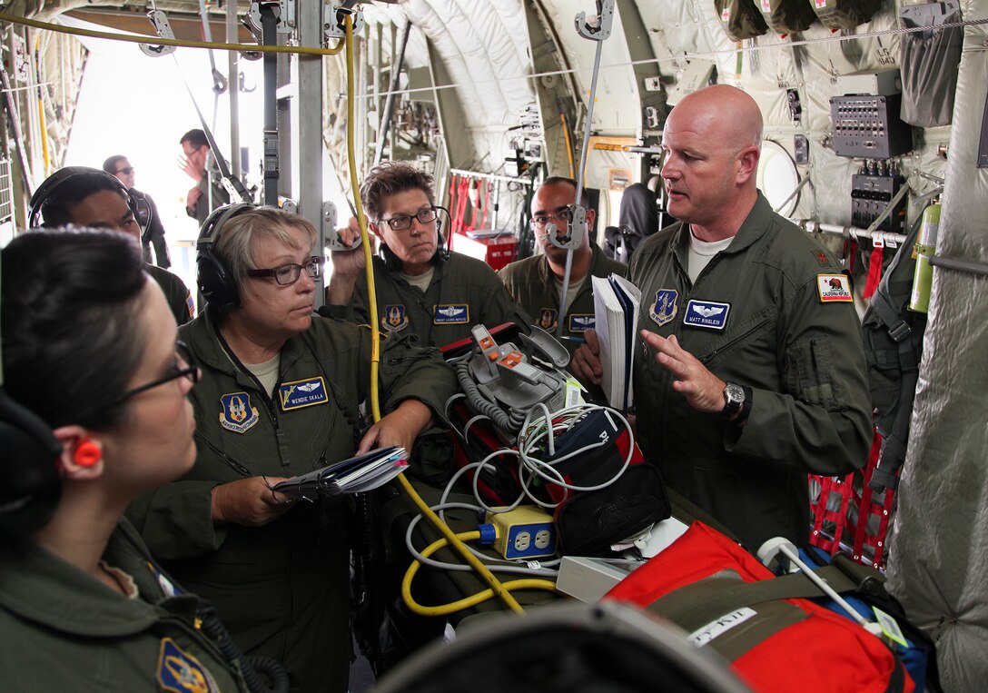 TRAVIS AIR FORCE BASE, Calif. -- Maj. Matthew Ringlein, aircraft commander from the California Air National Guard's 115th Airlift Squadron, give a pre-flight brief to members of the 349th Aeromedical Evacuation aboard a C-130J Super Hercules during 349th Air Mobility Wing Air Force Specialty Code training June 6, 2015, at Travis Air Force Base, California.  The 349th Aeromedical Evacuation Squadron transformed the four-engine tactical transport into a flying hospital. In turn, the CCATT teams from the 60th Surgical Operations Squadron and the 349th Aeromedical Staging Squadron established onboard what was essentially a portable intensive care unit dedicated to one very ill, simulated, "patient."  (U.S. Air Force photo/Lt. Col. Robert Couse- Baker/Released)