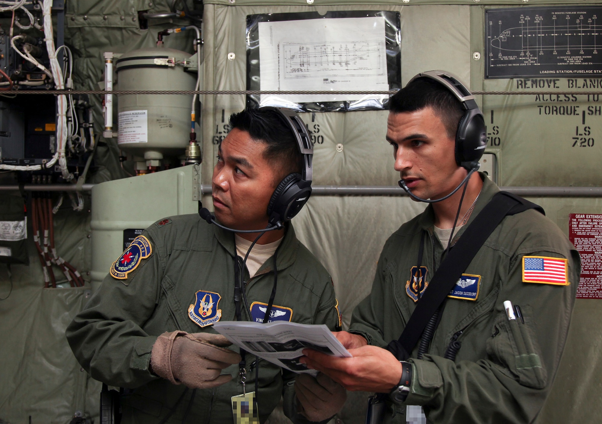 TRAVIS AIR FORCE BASE, Calif. -- Maj. Vincent Alipio (left) and Staff Sgt. Jamie Sussdorf, 349th Aeromedical Evacuation Squadron, configure a C-130J Super Hercules from the California Air National Guard's 146th Airlift Wing, Channel Islands Air National Guard Station, California. during 349th Air Mobility Wing Air Force Specialty Code training June 6, 2015, at Travis Air Force Base, California.  In preparation for the training, the 349th Aeromedical Evacuation Squadron transformed the four-engine tactical transport into a flying hospital. In turn, the CCATT teams from the 60th Surgical Operations Squadron and the 349th Aeromedical Staging Squadron established onboard what was essentially a portable intensive care unit dedicated to one very ill, simulated, "patient."  (U.S. Air Force photo/Lt. Col. Robert Couse-Baker/Released)