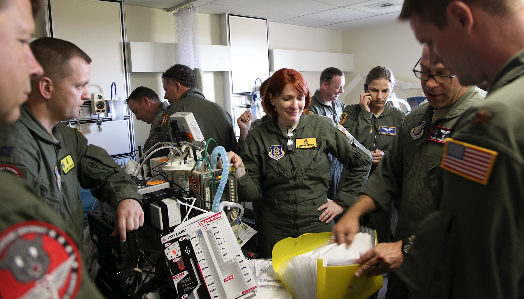 TRAVIS AIR FORCE BASE, Calif. -- Critical air transport team members prepare to practice transporting a simulated critically ill patient as part of a critical care air transport team during 349th Air Mobility Wing Air Force Specialty Code training June 6, 2015, at David Grant USAF Medcial Center, Travis Air Force Base, California.  In preparation for the training, the 349th Aeromedical Evacuation Squadron transformed the four-engine tactical transport into a flying hospital. In turn, the CCATT teams from the 60th Surgical Operations Squadron and the 349th Aeromedical Staging Squadron established onboard what was essentially a portable intensive care unit dedicated to one very ill, simulated, "patient."  (U.S. Air Force photo/Lt. Col. Robert Couse- Baker/Released)