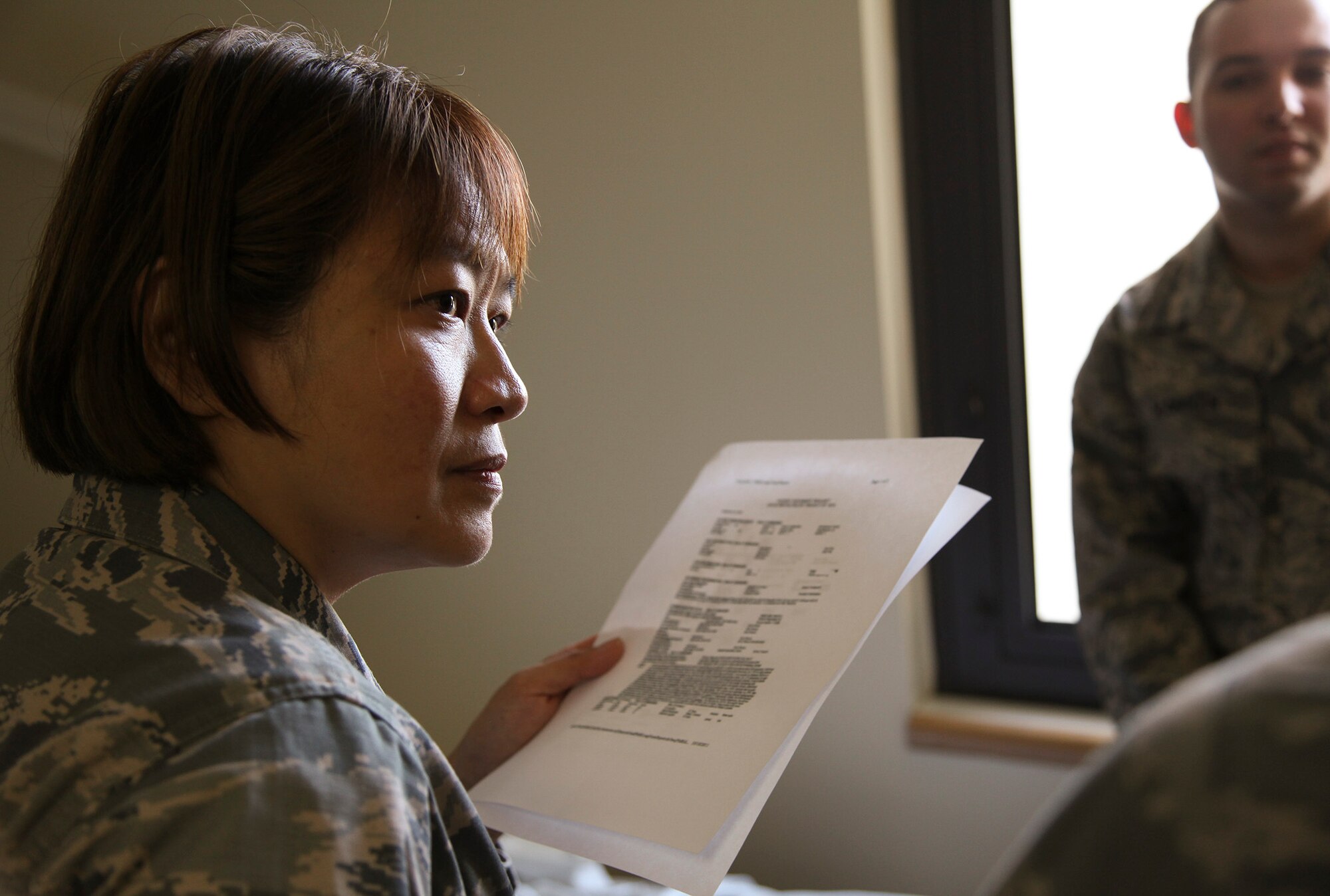 TRAVIS AIR FORCE BASE, Calif. -- Maj. Theresa Sun-Isbell, a critical care nurse with the 349th Aeromedical Staging Squadron, prepares to  practice transporting simulated critically ill patients as part of a critical care air transport team during 349th Air Mobility Wing Air Force Specialty Code training June 6, 2015, at David Grant USAF Medcial Center, Travis Air Force Base, California.  In preparation for the training, the 349th Aeromedical Evacuation Squadron transformed the four-engine tactical transport into a flying hospital. In turn, the CCATT teams from the 60th Surgical Operations Squadron and the 349th Aeromedical Staging Squadron established onboard what was essentially a portable intensive care unit dedicated to one very ill, simulated, "patient."  (U.S. Air Force photo/Lt. Col. Robert Couse-Baker)
