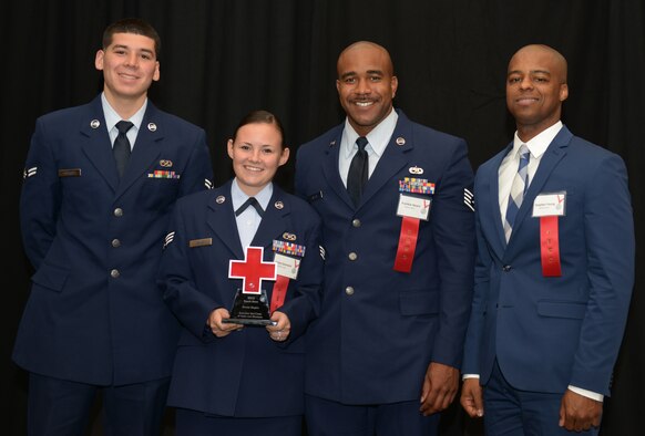 Airmen from the 366th Equipment Maintenance Squadron pose for a photo at the Riverside Hotel, in Boise, Idaho, June 16, 2015. They were awarded an American Red Cross Military Hometown Hero award for administering life saving first-aid after Airman 1st Class Saul Vasquez (left) tore his radial artery fixing an F-15E Strike Eagle. (U.S. Air Force photo by Senior Airman Brittany A. Chase/Released)
