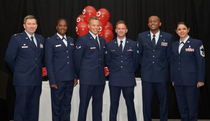 Airman 1st Class Gabriel Marshman (left-center), 366th Aerospace Medical Squadron public health technician, poses for a photo with 366th Medical Group leadership at the Riverside Hotel, in Boise, Idaho, June 16, 2015. Marshman received a Military Hometown Hero Award from the American Red Cross of Greater Idaho for being part of a search and rescue team who found a family that was stranded on an abandoned road in the middle of winter. (U.S. Air Force photo by Senior Airman Brittany A. Chase/Released)