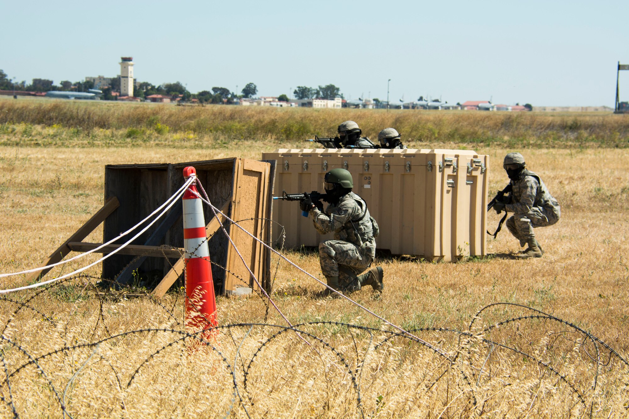 TRAVIS AIR FORCE BASE, Calif. -- A fire team of defenders from the 349th Security Forces Squadron engage enemy combatants with simunitions June 7, 2015 during the shoot move communicate course at Travis Air Force Base, California. More than 40 defenders took part in a various expeditionary combat skills training scenarios during the Air Force Specialty Code weekend. (U.S. Air Force photo/ Staff Sgt. Christopher Carranza)