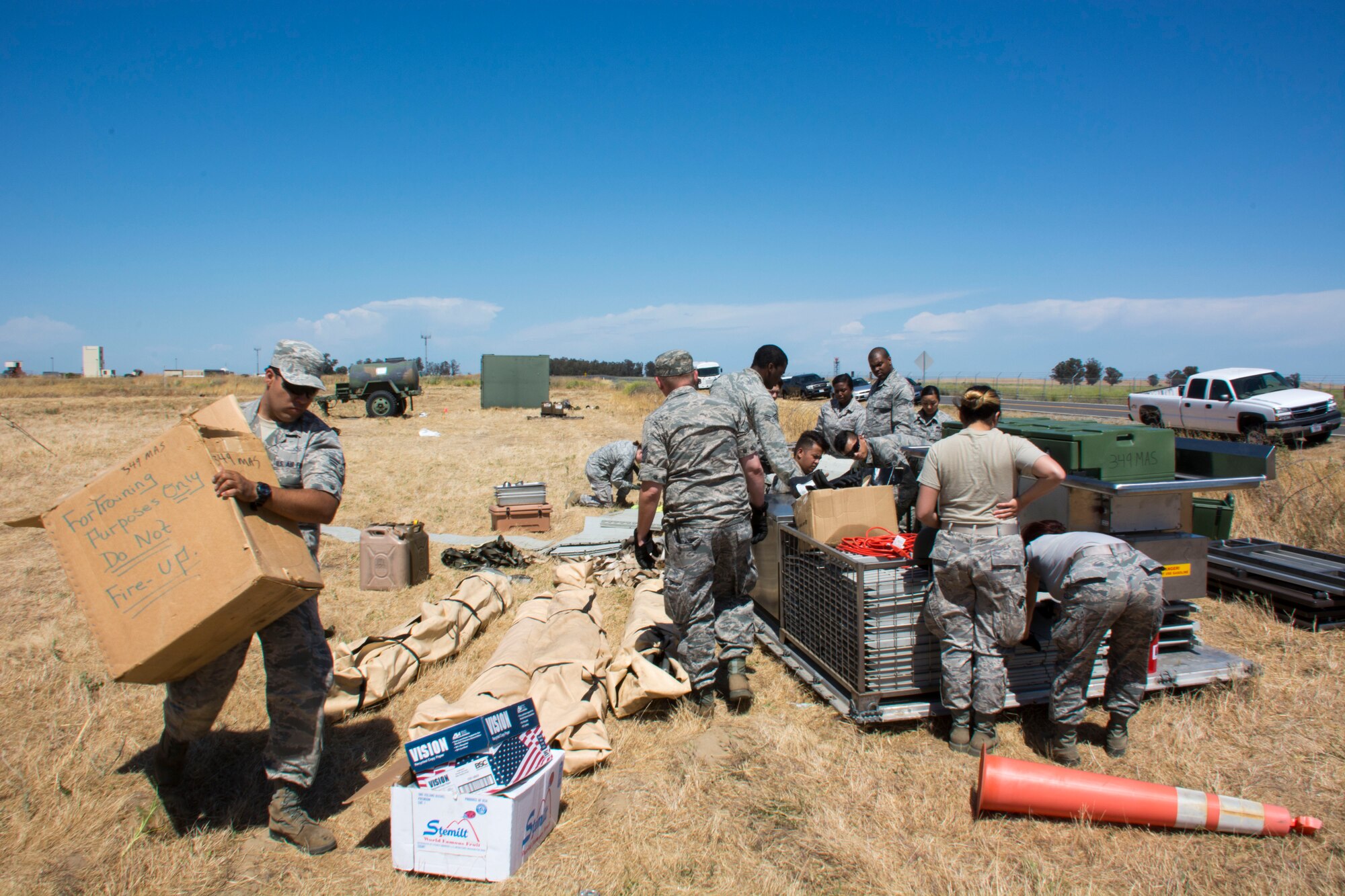 TRAVIS AIR FORCE BASE, Calif. -- Airmen from the 349th Force Support Squadron break down and package all the equipment that is the single palletized expeditionary kitchen June 6, 2015 during the Air Force Specialty Code weekend at Travis Air Force Base, California. Approximately 20 FSS members supported more than 40 defenders in the field. (U.S. Air Force photo/ Staff Sgt. Christopher Carranza)